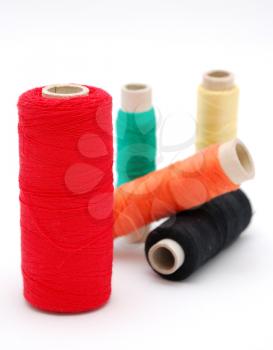 Detail image of various colored threads on white background.