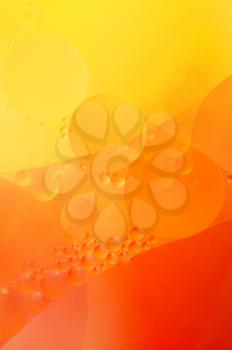 Abstract red, orange background from floating oil bubbles in the water.