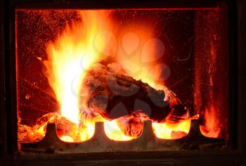 Closeup shot with burning log in fireplace.
