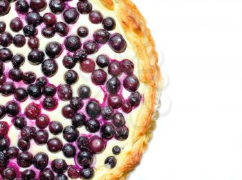 Top view on a blueberry cheese pie placed on a white background.