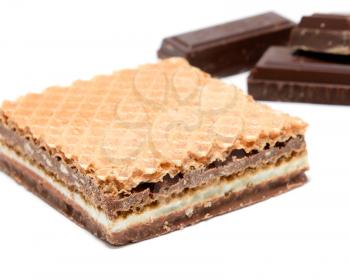 Wafer with hazelnut and milk cream with pieces of dark chocolate on white background. 