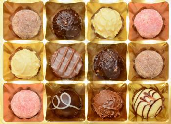 Top View of Belgian Chocolate Pralines in the Box. Sweet Pralines Close Up Background.
