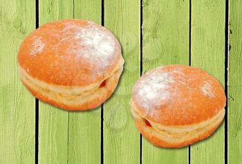 Two donuts with strawberry jam filling.