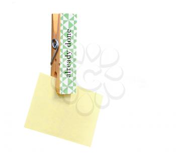 Yellow stick note paper pinned on wooden peg isolated on white background. Copy space for other notes on right side.