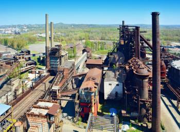 Aerial view of the old rusty abandoned ironworks factory area. Old ironworks factory with chimneys.