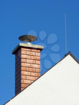 Chimney and lightning conductor rod on family house.