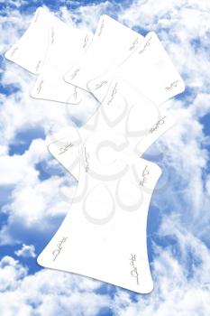 Joker Playing Cards Scatered Over The Blue Cloudy Sky