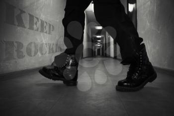 Men's Leather High Combat Boots In A Long Hallway With Text Keep Rockin' On The Wall