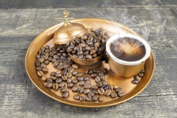 Turkish coffee with traditional copper serving set and coffee beans