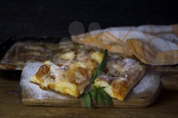 Apricot Cake With Mint Leaves On a Rustic Wooden Board