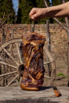 Whole Smoked Bacon Slab Held By Woman's Hand In A Rustic Environment. Delicious Domestic Food