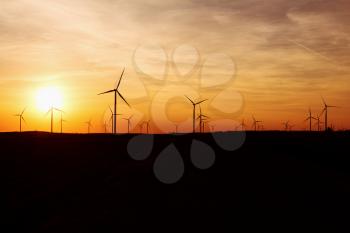Wind Turbines Over Sunset Sky Generating Electricity. Sustainable Energy Power Generators, Renewable Power Supply