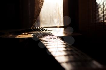Acoustic Guitar In Music Studio Close up. Shined By The Sun At The Golden Hour 