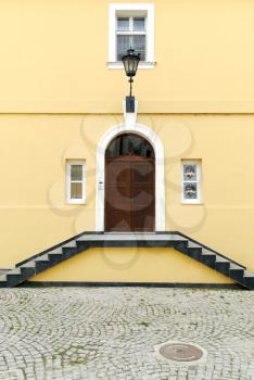 Old yellow house with staircase entrance
