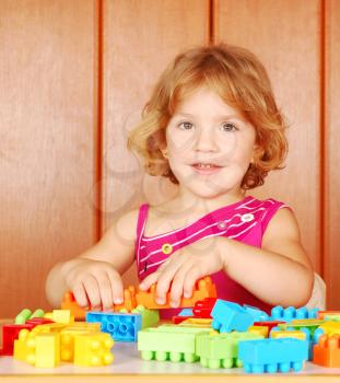 Happy little girl play with toy blocks