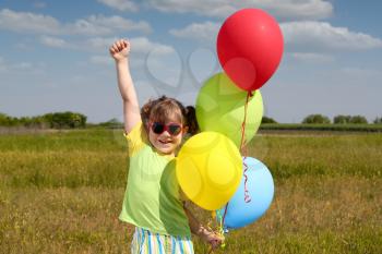 happy little girl with balloons
