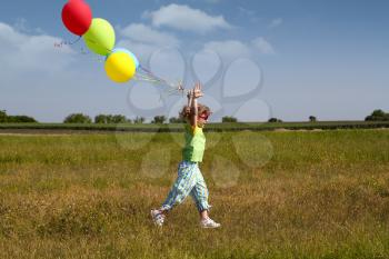 little girl running with balloons