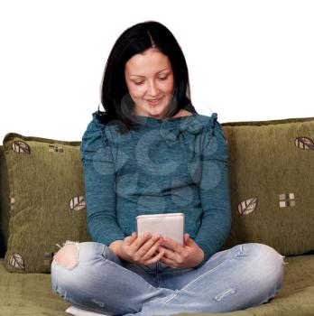 teenage girl sitting on bed and play with tablet pc