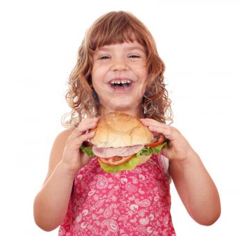 happy little girl eat big sandwich on white 
