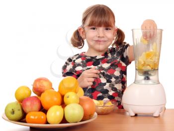 beautiful little girl make fruit juice