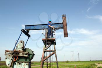 oil worker and pump jack industry scene