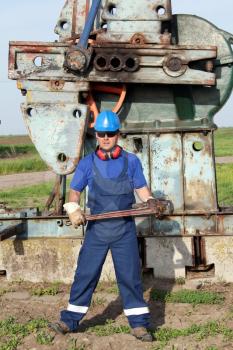 oil worker with pipe wrench