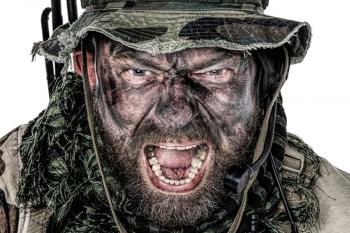 United States Commando face studio shot. Mouth opened, soldier yelling, emitting intimidate formidable frightening scream. Closeup portrait, cropped, isolated
