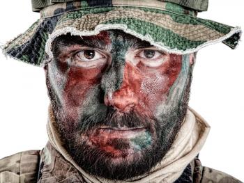 Special forces United States in Camouflage Uniforms studio shot. Wearing jungle hat, Shemagh scarf, painted with red and green face. Studio shot isolated