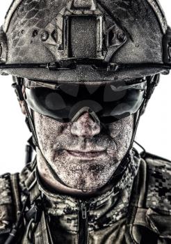 Close up studio shot of special forces soldier in field uniforms and combat helmet, portrait isolated on white background. Protective goggles glasses are on