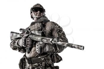 Half length cropped studio shot of big muscular soldier in field uniforms with sniper rifle, portrait isolated on white background lot of copyspace. Protective goggles glasses are on