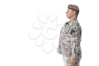 Army Ranger from Special Troops Battalion in universal Camouflage pattern Uniforms and Tan beret with Ranger Regiment crest is standing to attention. National holidays Veterans Day, Memorial Day. National Anthem is played