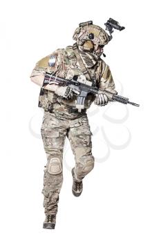 Elite member of US Army rangers in combat uniforms with his shirt sleeves rolled up, in helmet, eyewear and night vision goggles, running in action turning around. Studio shot, white background
