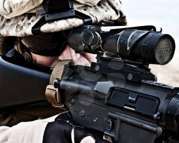Close-up shot of US marine shooting his rifle