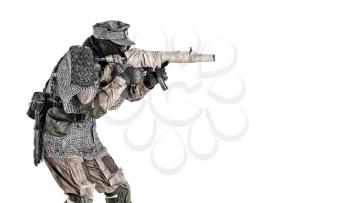 Nuclear post-apocalypse survivor, alternative history nazi soldier or partisan in wool field cap, face mask, glasses and handmade armor, aiming submachine gun in camera studio shoot isolated on white