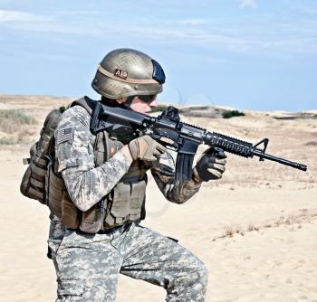 US soldier going through the desert during the military operation 