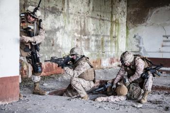 Squad of US marines in ruined building