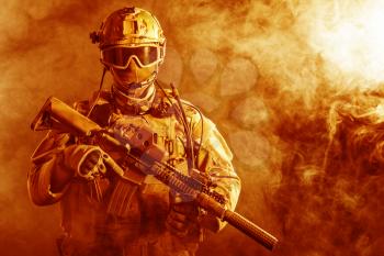 Special forces soldier with rifle in the fire