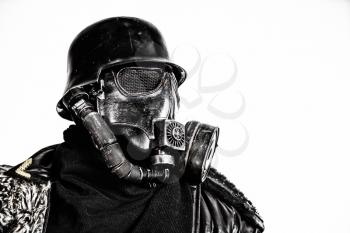 Futuristic nazi soldier gas mask and steel helmet with schmeisser handgun isolated on white studio shot closeup portrait