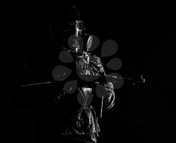 Futuristic nazi soldier gas mask and steel helmet with schmeisser handgun black background studio shot