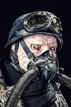 Ugly face of Futuristic nazi soldier in gas mask and steel helmet. Skin burned by atomic flame