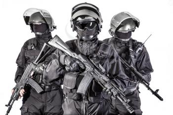 Russian special forces operators in black uniform and bulletproof helmets
