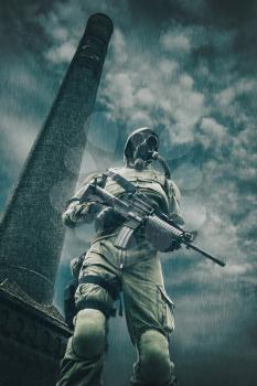 Post apocalypse. Sole survivor in tatters and gas mask on the ruins of the destroyed city