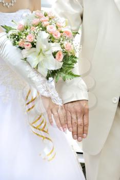 Beautiful white wedding bouquet in hands of the bride.
