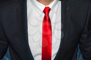 Executive dressed in business attire, red silk tie and grey wool suit