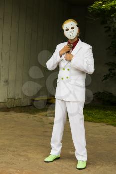 Lviv, Ukraine - May 23.2015:Cosplayer boy  posing in a white suit and a hockey mask  , photo taken at cosplayers meeting outdoor in Lviv city.May 23.2015