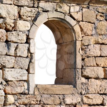 Window in the ancient stone wall white isolated