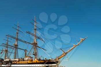 Beautiful sailing vessel with big masts on the mooring