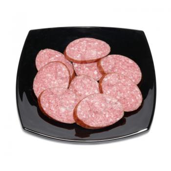 Sliced sausage with black plate isolated on white
