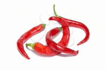 Stack of red hot chili peppers isolated on white