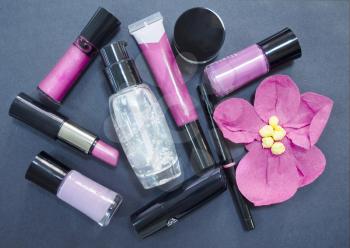 Decorative cosmetics isolated on dark background. Different makeup products. Close up.